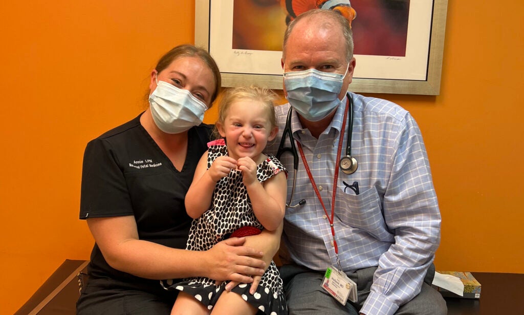 Zoey Keipp is pictured with pediatric cardiologist Brian J. Holland, M.D., during an office visit