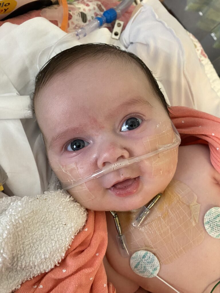 Hazel Moore smiles up at camera while distractor device is in place.