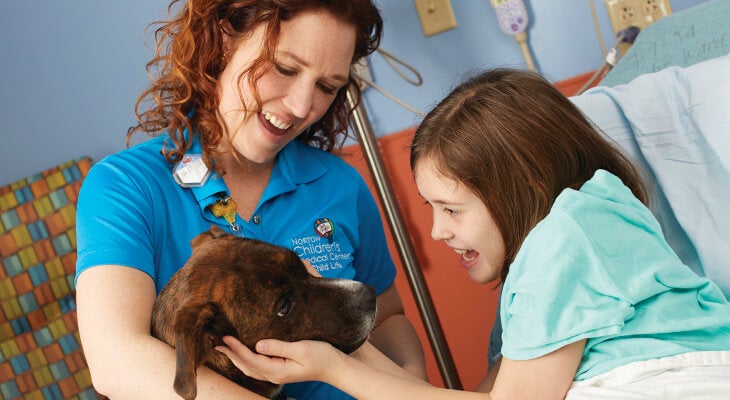 Norton Healthcare celebrating its staff of facility dogs